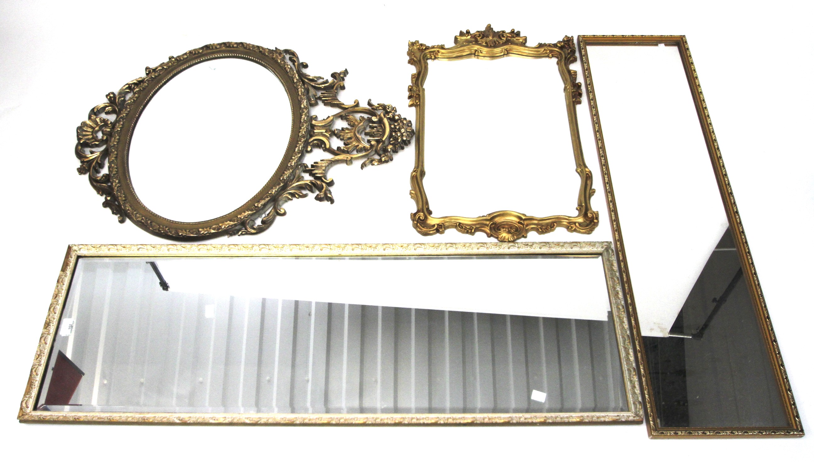 A collection of four gilt framed wall mirrors.