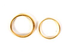 Two gold and yellow metal wedding bands. One 22ct, size L, 1.