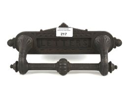 A Victorian cast metal letterbox plate and knocker.