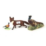 Two Beswick pheasants and a fox.