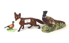 Two Beswick pheasants and a fox.