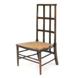 An early 20th century stained Heals style rush seated chair.