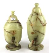 Two large alabaster stone water dispensers.