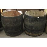 Two large coopered wooden barrels adapted into planters.