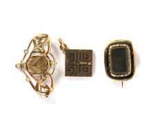 Two yellow metal brooches and a 9ct gold pendant. The pendant of geometric design, 3.