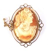 A yellow metal mounted cameo brooch. Depicting a lady in classical dress, the mount stamped '9ct' 5.