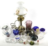 An assortment of glassware and a brass oil lamp.