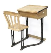 A 20th century wooden school desk on cast iron base.