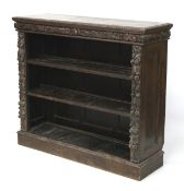 An early 20th century heavily carved oak Flemish style open bookcase.
