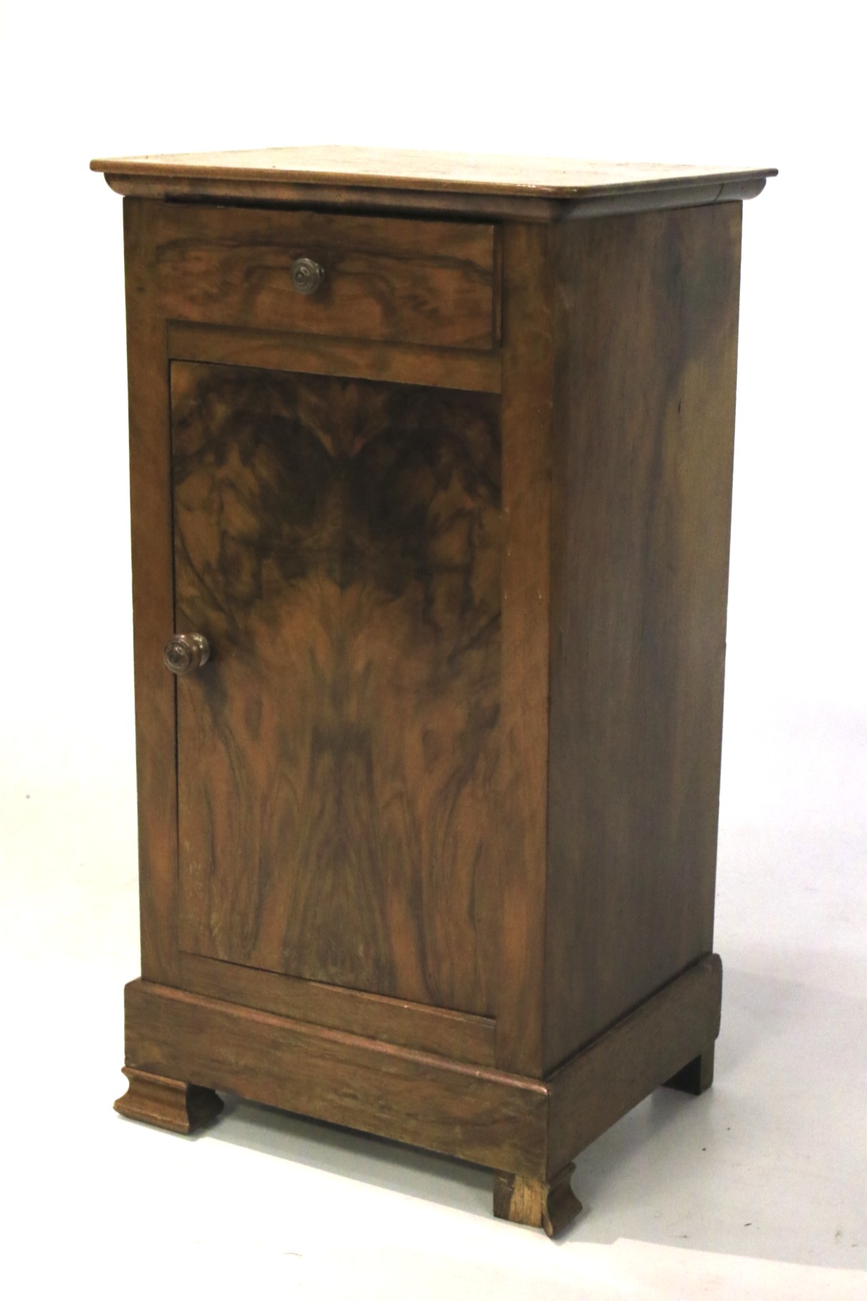 An early 20th century continental walnut veneer pot cupboard.