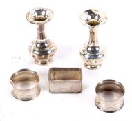 Two silver bud vases (marks rubbed) and three assorted silver napkin rings.