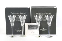 Two boxed pairs of Waterford crystal champagne flutes.