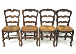 A set of four rush seated oak chairs.