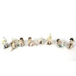 Eight continental German porcelain piano babies.