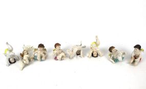 Eight continental German porcelain piano babies.