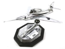 A contemporary stainless steel table lighter modelled as a jet.