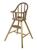 A contemporary wooden high chair.