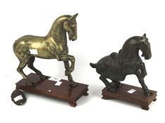Two bronze and cast metal horses.