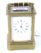 An early 20th century small brass cased carriage clock retailed by Ortner & Houle.