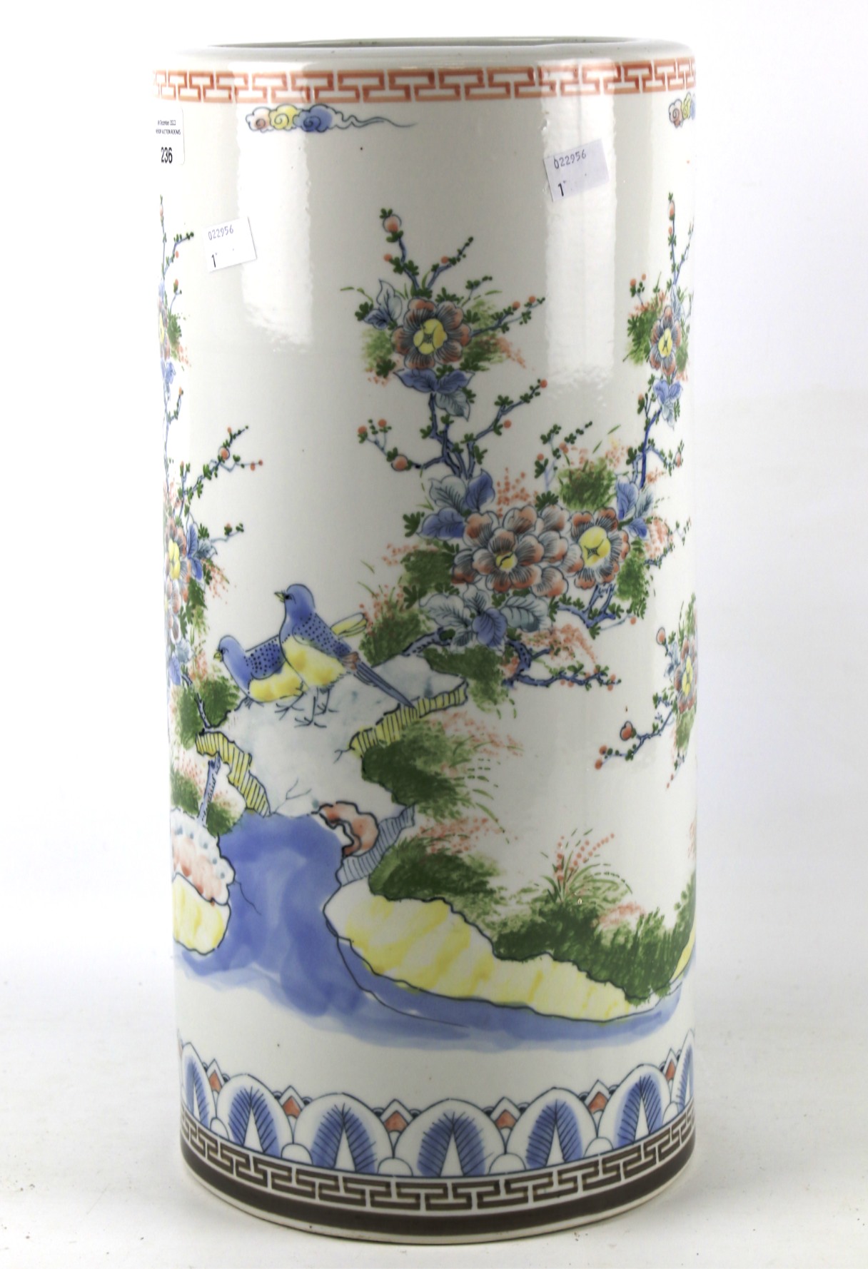 A large cylindrical Japanese ceramic vase or umbrella stand.