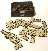 A turned wooden chess set and a set of dominoes.