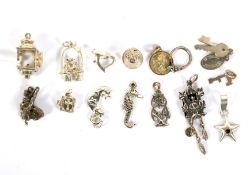 Fifteen silver and white metal charms. Modelled as animals, a lantern, bible, etc, 21.