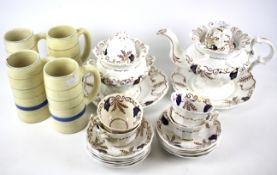 An early 20th century ceramic tea service, together with four Clarice Cliff tankard style mugs.