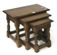 A 20th century oak nest of three side tables.