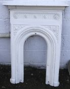A white painted cast iron Victorian bedroom fireplace surround.