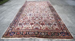 A large early 20th century room size persian carpet.