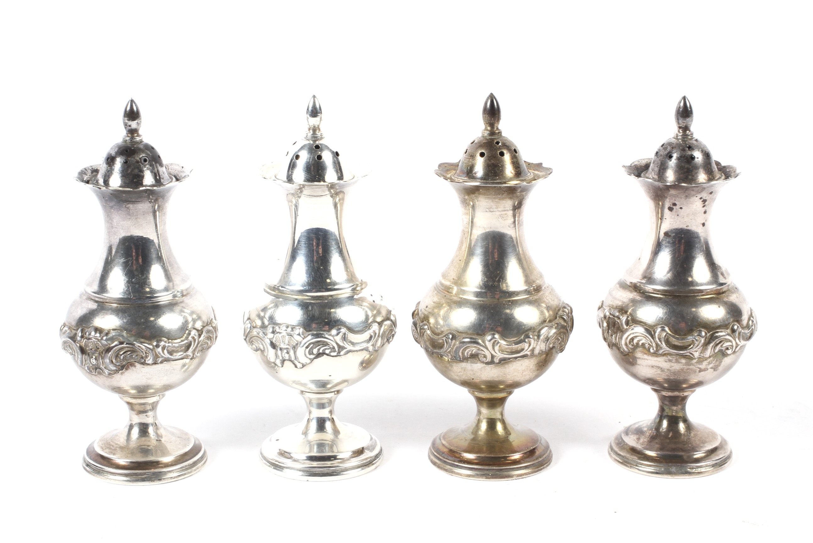 A set of four 20th century silver pepper shakers.
