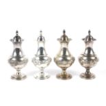 A set of four 20th century silver pepper shakers.