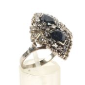 A sapphire and diamond 'shaped' cluster ring.