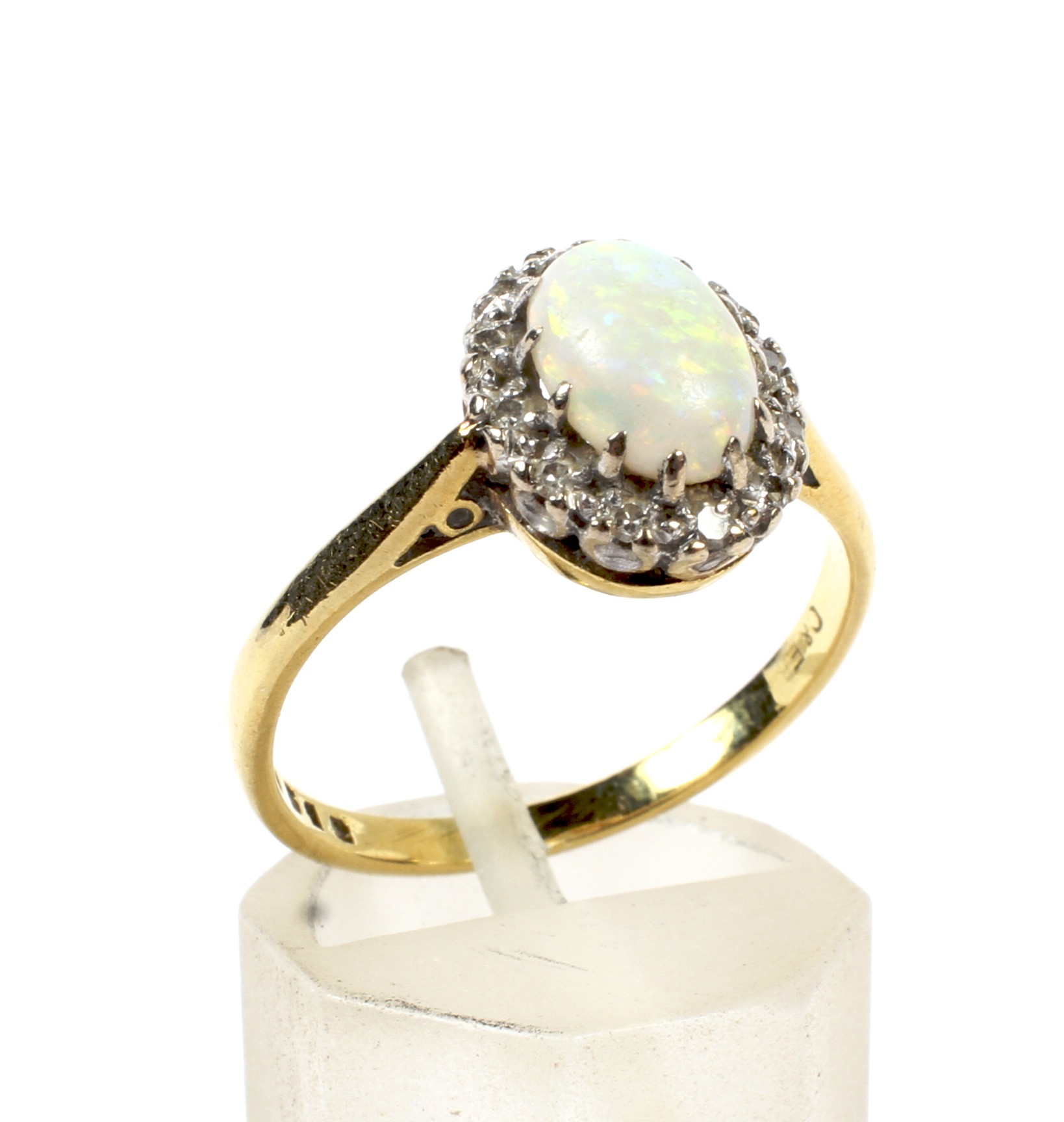 An 18ct gold, opal and diamond oval cluster ring.
