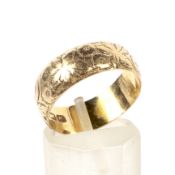 A late Victorian 18ct gold floral chased broad wedding band.