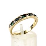 An 18ct gold emerald and diamond half-eternity ring.