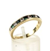 An 18ct gold emerald and diamond half-eternity ring.