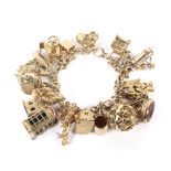 A 9ct gold fancy figure-of-eight link 'charm' bracelet.