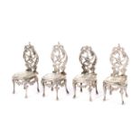 A set of four minature silver French style chairs.