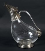 A silver plated glass claret jug in the form of a bird, Of lobed form, with plated handle, tail,