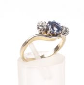 A mid 20th century gold, sapphire and diamond three stone cross-over ring.