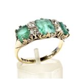 A late Victorian 18ct gold, emerald and diamond carved half-hoop ring.