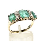 A late Victorian 18ct gold, emerald and diamond carved half-hoop ring.