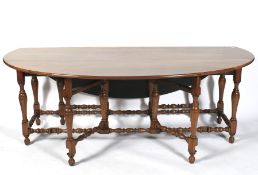 A 20th century elm wake drop leaf table and six chairs.