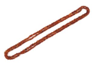 An unusually long amber compressed baroque and round tumble-polish bead continuous necklace.