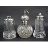 Three silver topped glass shakers. Including an atomiser.