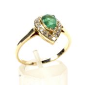 A modern emerald and diamond pear-shaped cluster ring. Centred with a pear-shaped emerald approx. 0.