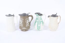 A group of 19th century Staffordshire pottery and stoneware relief-moulded pewter-mounted jugs.