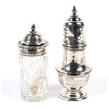 A George VI silver shaker and a silver topped glass shaker.