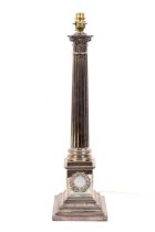 A Victorian silver Corinthian column candletick later adapted into a table lamp base.
